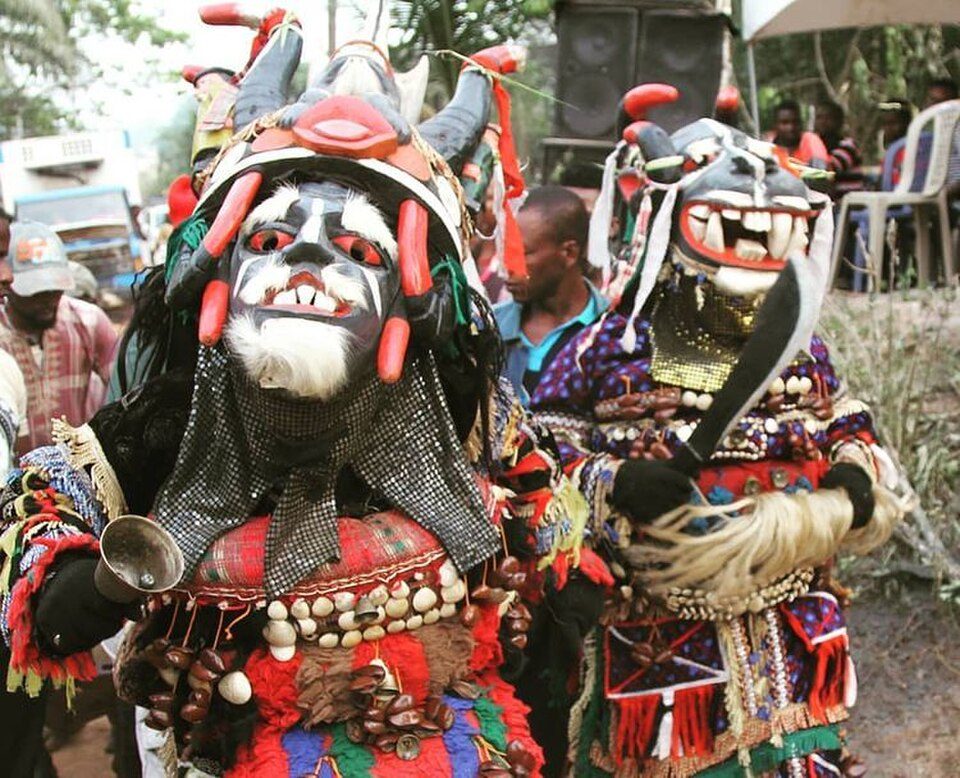 Igbo masquerade dancers with horned headdresses