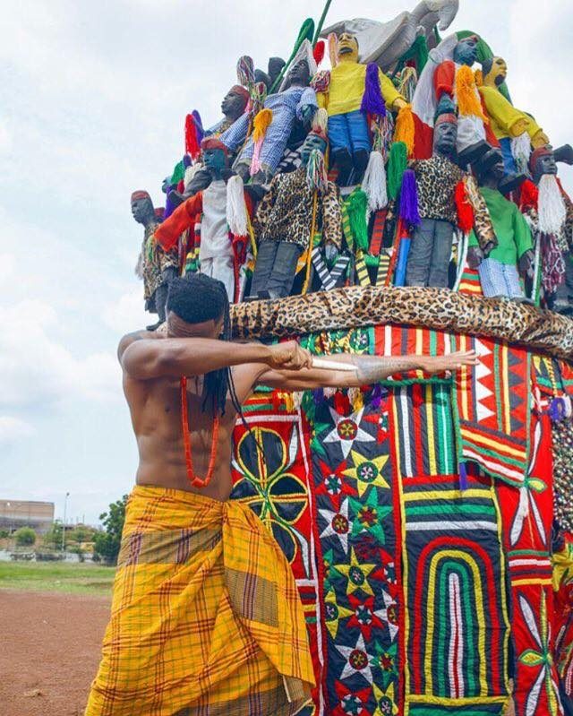 Ijele masquerade with figurines and tassels