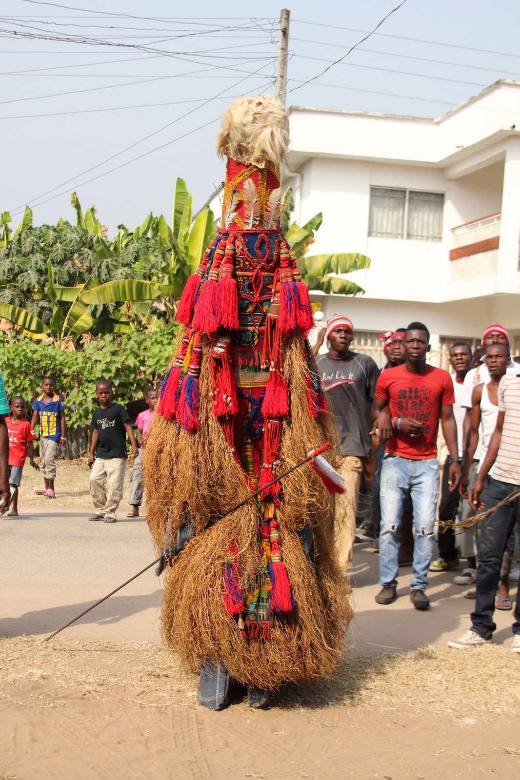 Igbo masquerade in raffia and leopard print regalia
